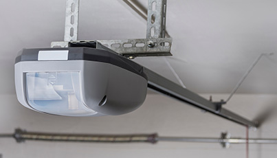 Garage door opener motor mounted on ceiling